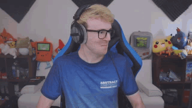 a man wearing headphones and a blue shirt that says abstract on it