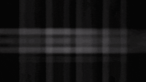 a white circle on a black background with a shadow on it .