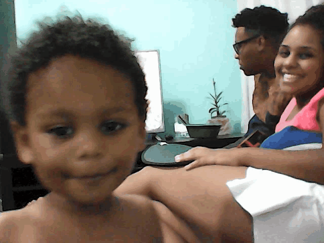 a man and a woman are sitting next to a child