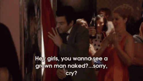 a man in a suit and tie is talking to a woman in a red dress while holding a bottle of champagne ..