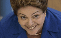 a woman wearing a blue jacket is smiling and looking at the camera