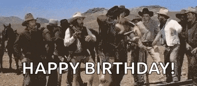 a group of cowboys are standing in the desert with the words `` happy birthday '' written on the bottom .