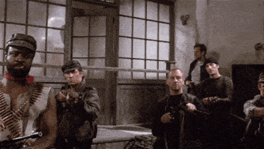 a group of men holding guns in a room with a window