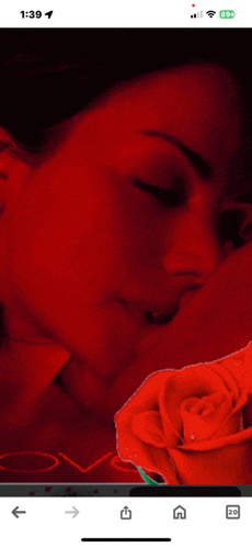 a phone screen shows a picture of a woman and a rose with the time of 1:39