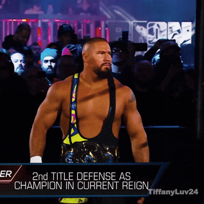 a man in a wrestling ring with the words 2nd title defense as champion in current reign behind him