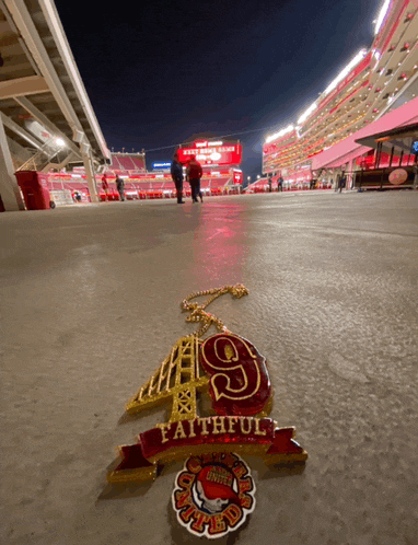 a faithful 9 necklace is on the ground