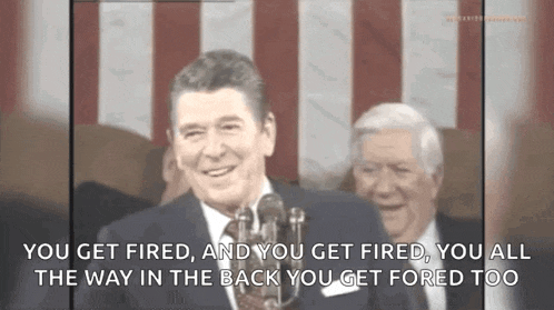 a man speaking into a microphone with the words you get fired
