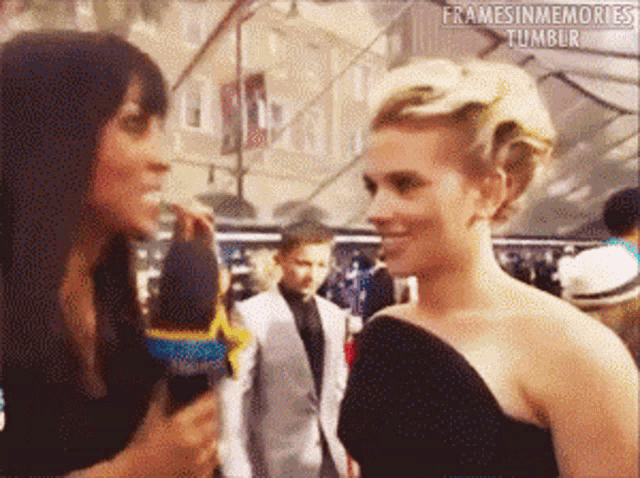 a woman is talking into a microphone while another woman looks on and the words framesinmemories tumblr can be seen on the bottom