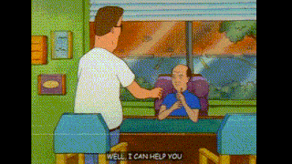 a man in a white shirt is standing next to a bald man in a blue shirt .