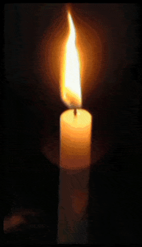 a picture of a lit candle with the word " it us " in the lower right corner