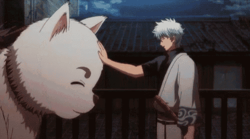 a man is petting a white dog 's head while holding a sword
