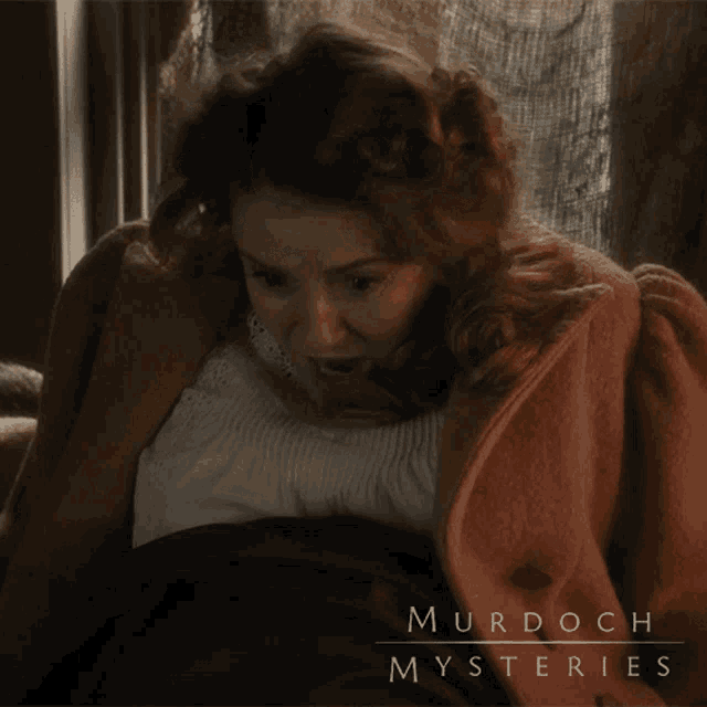 a poster for murdoch mysteries shows a woman in a red coat