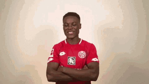 a man in a red shirt with a lotto logo on the sleeves