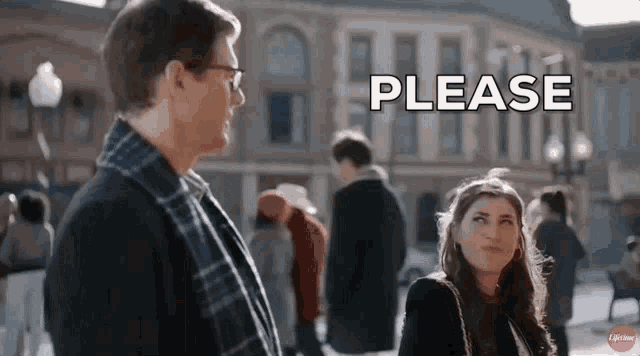 a man and a woman are standing next to each other on a city street and the man is asking the woman to please .