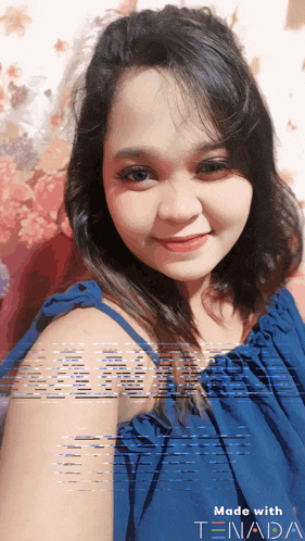 a woman in a blue dress is smiling with the words made with tenada written below her