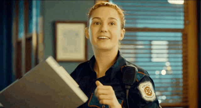 a woman in a uniform with a badge that says justice