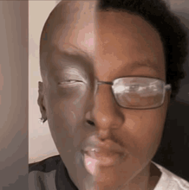 a close up of a man 's face with half of his face covered in makeup