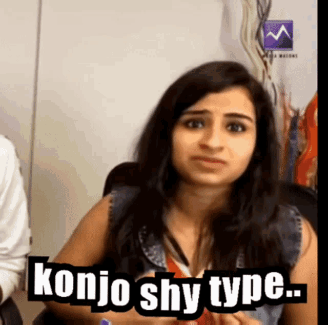 a woman says konjo shy type in front of a white wall