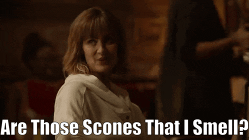 a woman says " are those scones that i smell " in a dark room