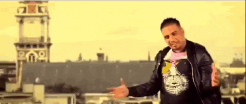 a man is standing on a rooftop with his arms outstretched .