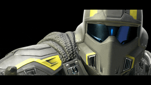 a close up of a person wearing a helmet with the letter t on the front
