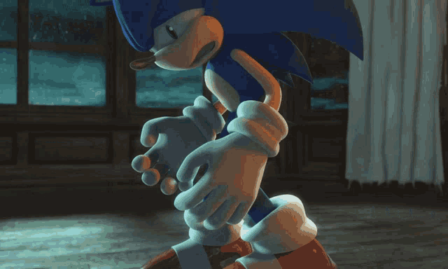 sonic the hedgehog is standing in a dark room