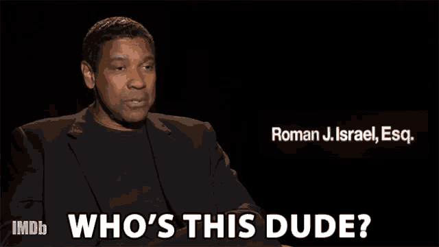 a man in a suit says " who 's this dude " in front of roman j. israel