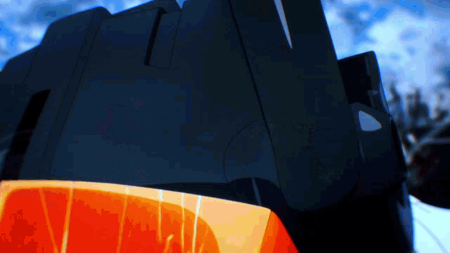 a close up of an orange and black object with a blue sky behind it