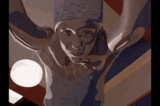 a statue of a man with horns is hanging from the ceiling of a building .