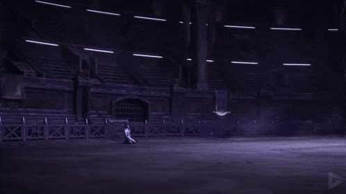 a purple flame is coming out of a dark room