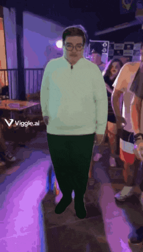 a man in a white sweater and green pants is standing in front of a group of people with a purple background