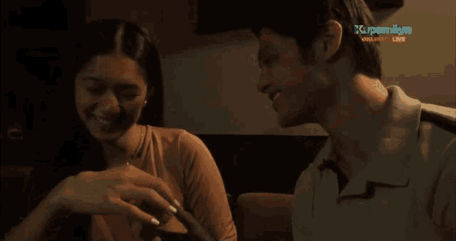 a man and a woman are sitting next to each other on a screen that says kapamilya