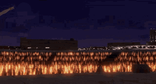 a girl in a bikini stands in front of a fireworks display at night