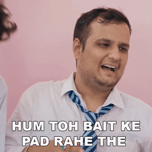a man in a white shirt and tie says hum toh bait ke pad rahe the
