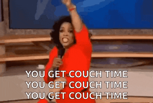 a woman in a red shirt is holding a microphone and saying you get couch time you get couch time