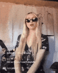 a blonde woman wearing sunglasses and a black dress says i 'm so happy i can 't explain fern joined