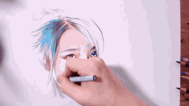 a person is drawing a person 's face with colored pencils