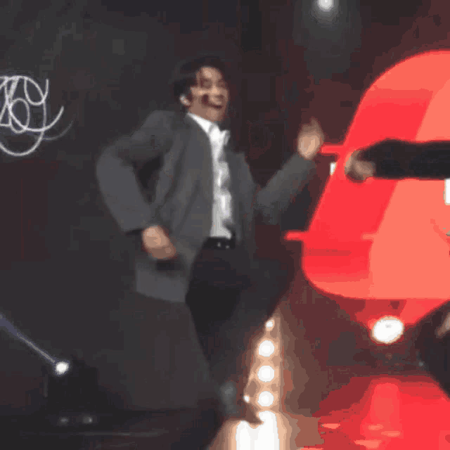 a blurry picture of a man in a suit dancing
