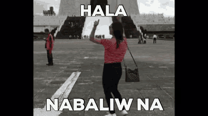 a woman is standing in front of a building with the words hala nabawi na written on the bottom