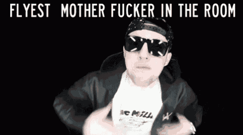 a man wearing sunglasses and a shirt that says ' flyest mother fucker in the room ' on it