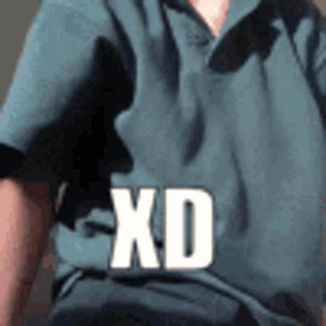 a man in a blue shirt with the word xd on his shirt .