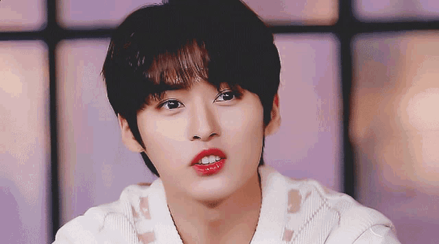 a close up of a person 's face with red lipstick