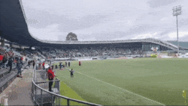 a soccer stadium with a yellow flag in the middle