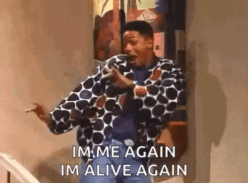 a man in a polka dot jacket is standing on a set of stairs and screaming .