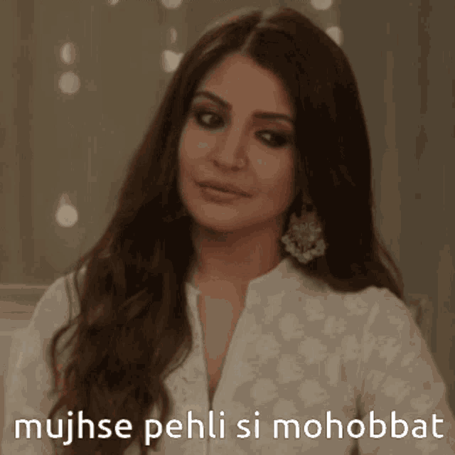 a woman in a white shirt with the words mujhse pehli si mohobbat on the bottom