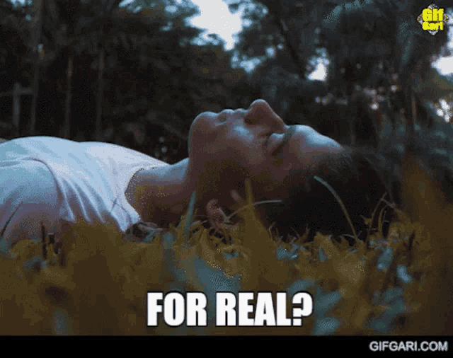 a woman laying in the grass with the words " for real " written below her