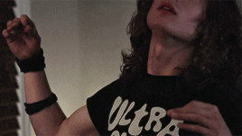 a man wearing a black shirt with the word ultra on it