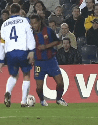 a soccer player with the number 10 on his shorts kicks the ball