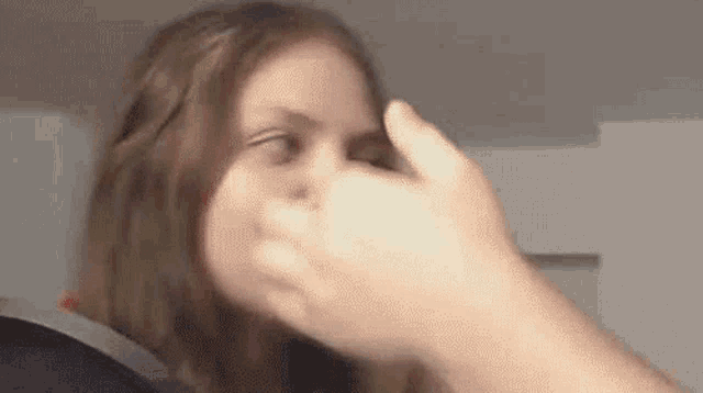 a close up of a person touching a woman 's face with their hand .