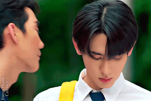 a couple of men are standing next to each other and one of them is wearing a white shirt and tie .